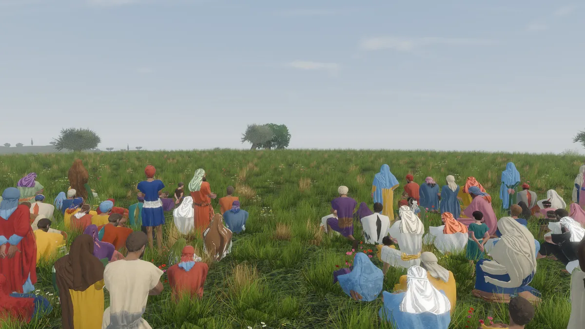 Men, women and children seated together on a grassy hillside